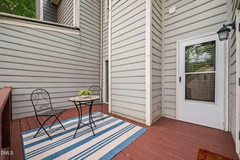 a bedroom with a bed and a table in it with window