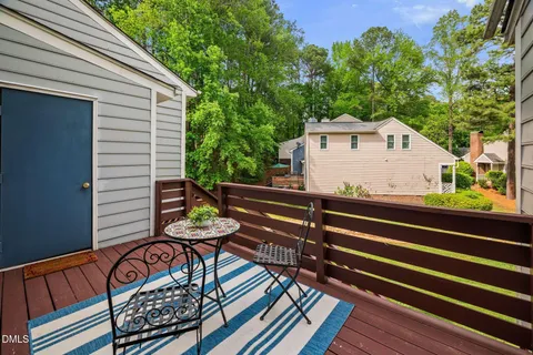 a view of a patio with two chairs and a potted plant