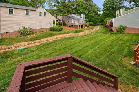 a view of a chairs setting in the backyard of a house