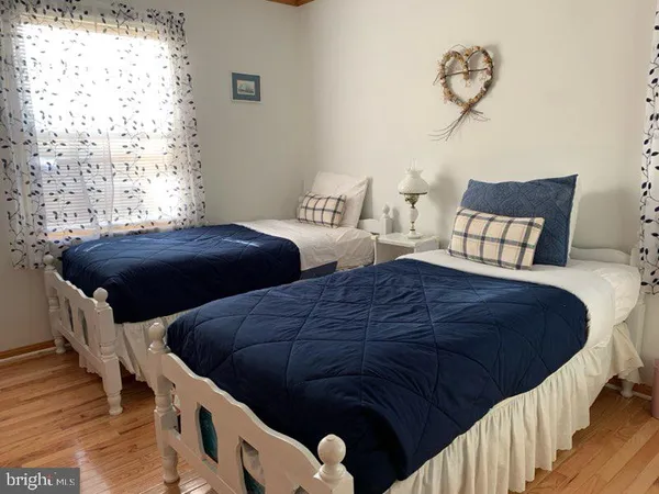 a bedroom with two beds and a window