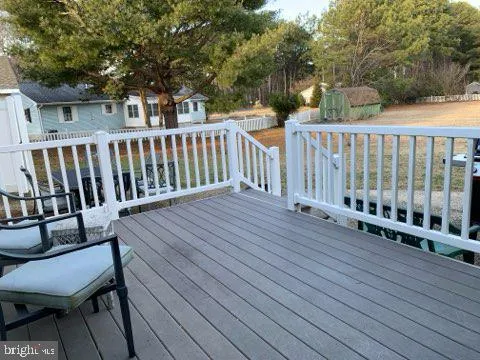 a view of a wooden chairs on deck