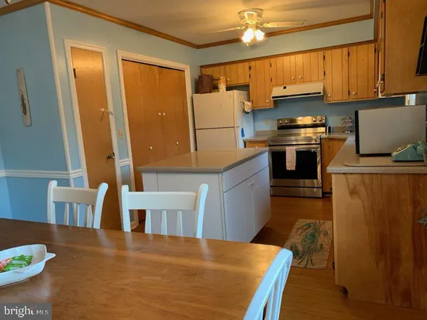 a kitchen with stainless steel appliances a stove refrigerator sink and cabinets