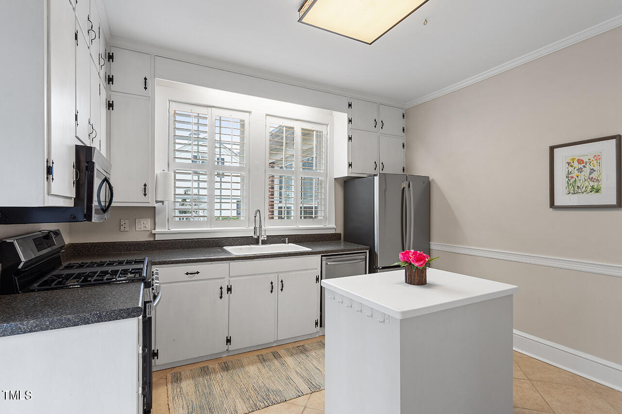 1310 Williamson Drive Raleigh, NC 27608 - Photo 22 of 43 a kitchen that has a sink and a stove in it