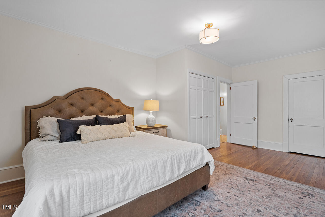 1310 Williamson Drive Raleigh, NC 27608 - Photo 24 of 43 a bedroom with a bed and a night stand