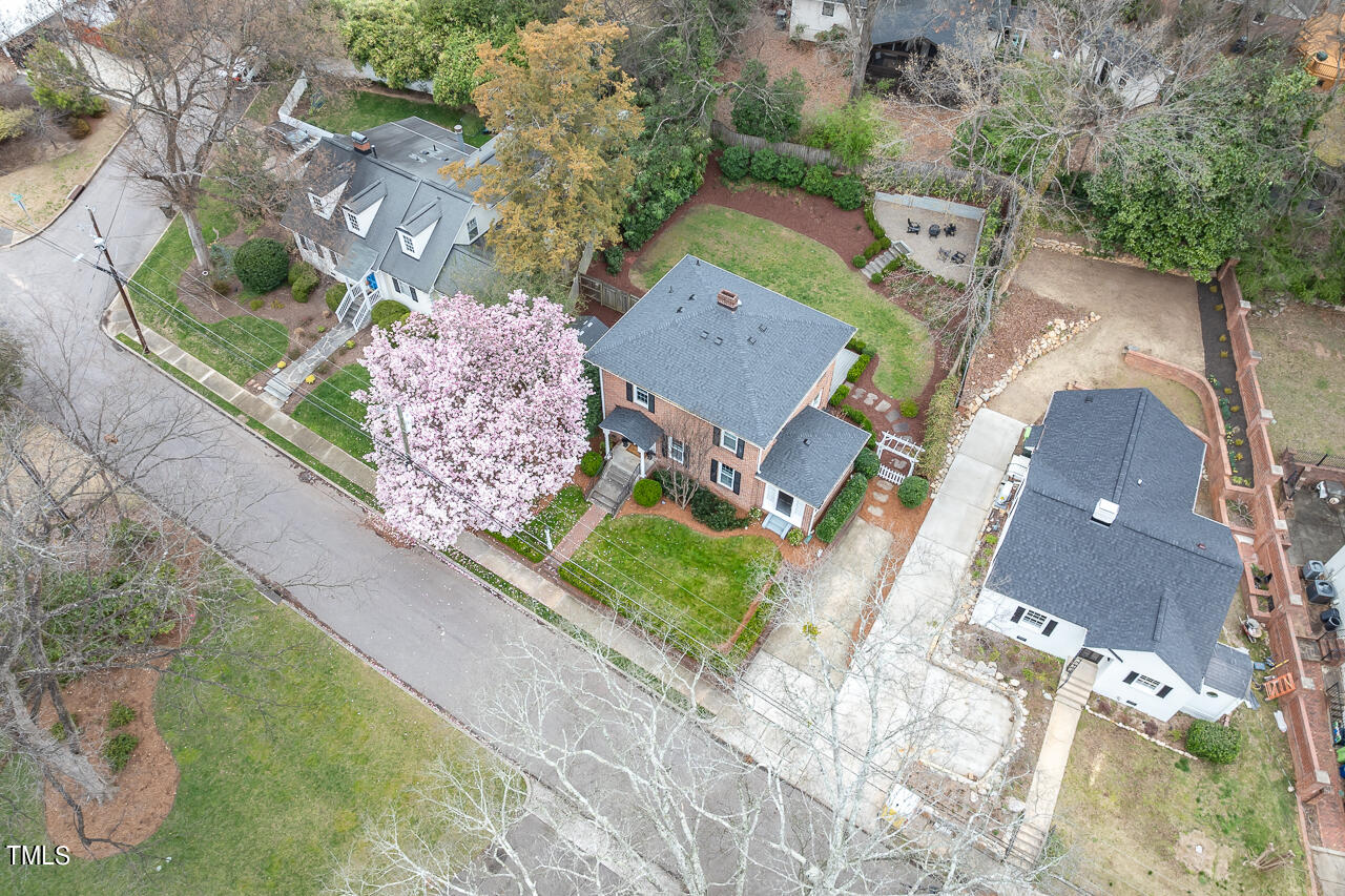 1310 Williamson Drive Raleigh, NC 27608 - Photo 35 of 43 an aerial view of a house with a yard and trees