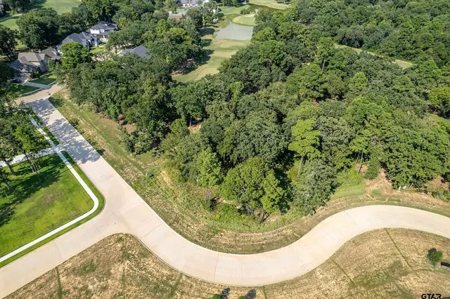 a view of a swimming pool with a yard
