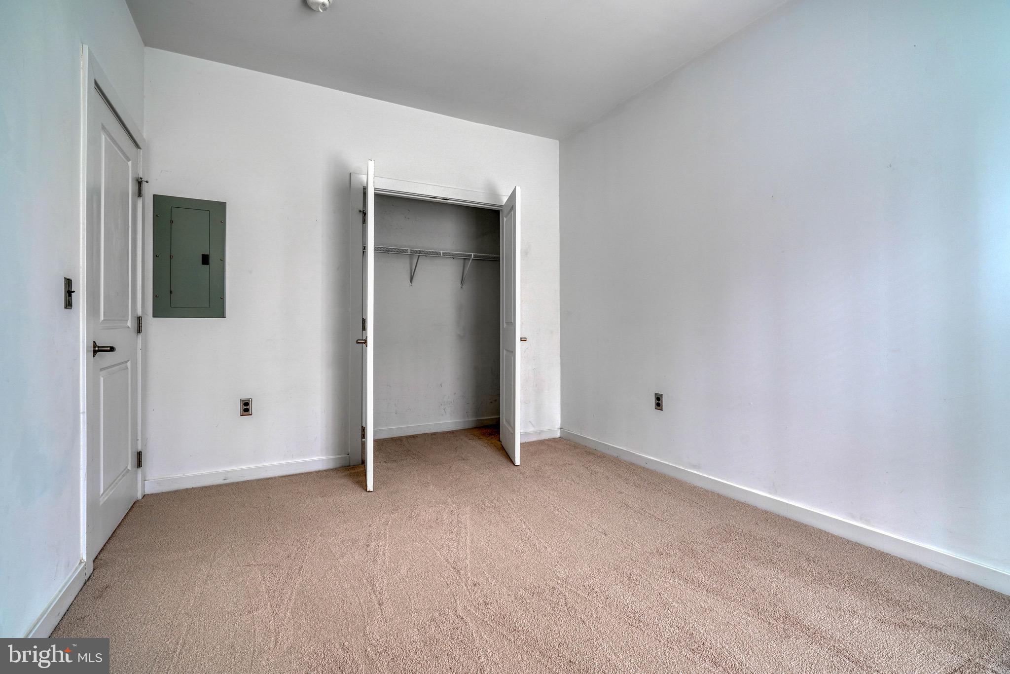 2007 Clipper Park Road, Unit 123 Baltimore, MD 21211 - Photo 16 of 25 a view of an empty room with closet and wooden floor