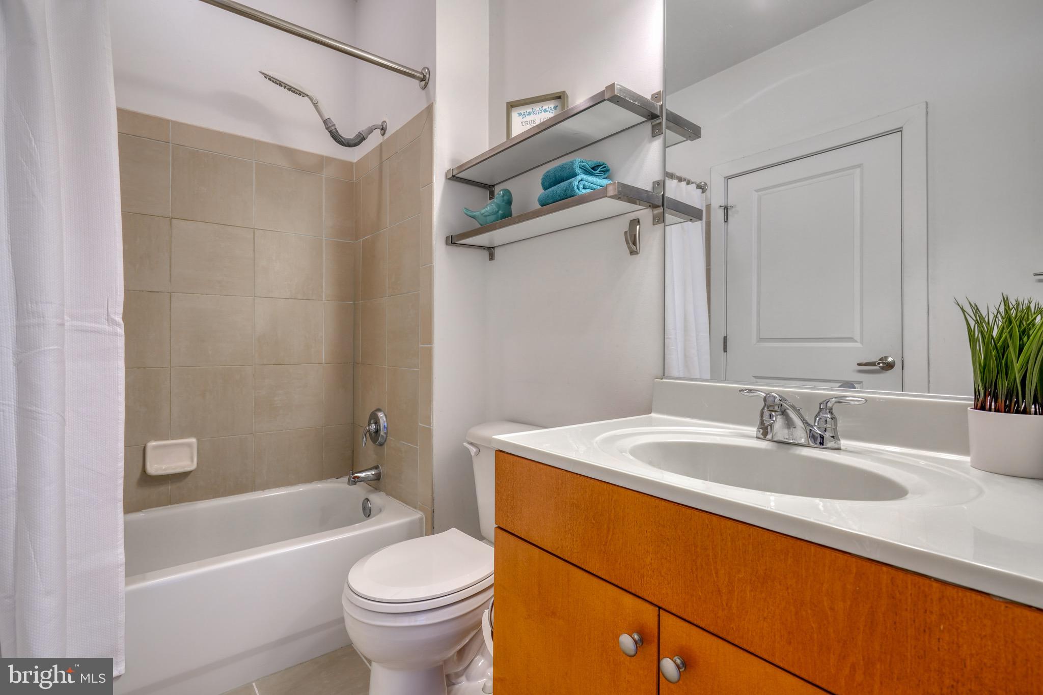 2007 Clipper Park Road, Unit 123 Baltimore, MD 21211 - Photo 18 of 25 a bathroom with a sink a toilet and shower