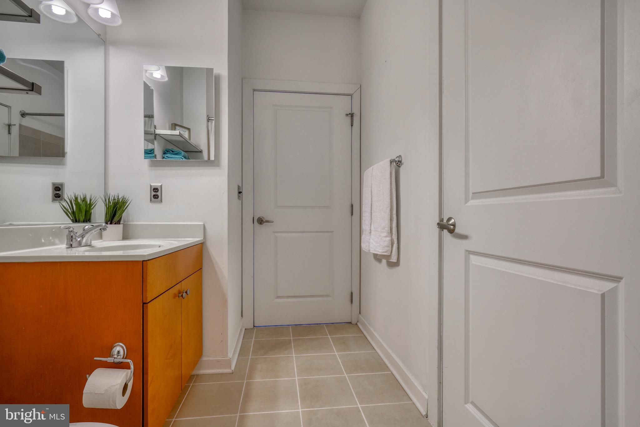 2007 Clipper Park Road, Unit 123 Baltimore, MD 21211 - Photo 20 of 25 a bathroom with a granite countertop sink a toilet and shower