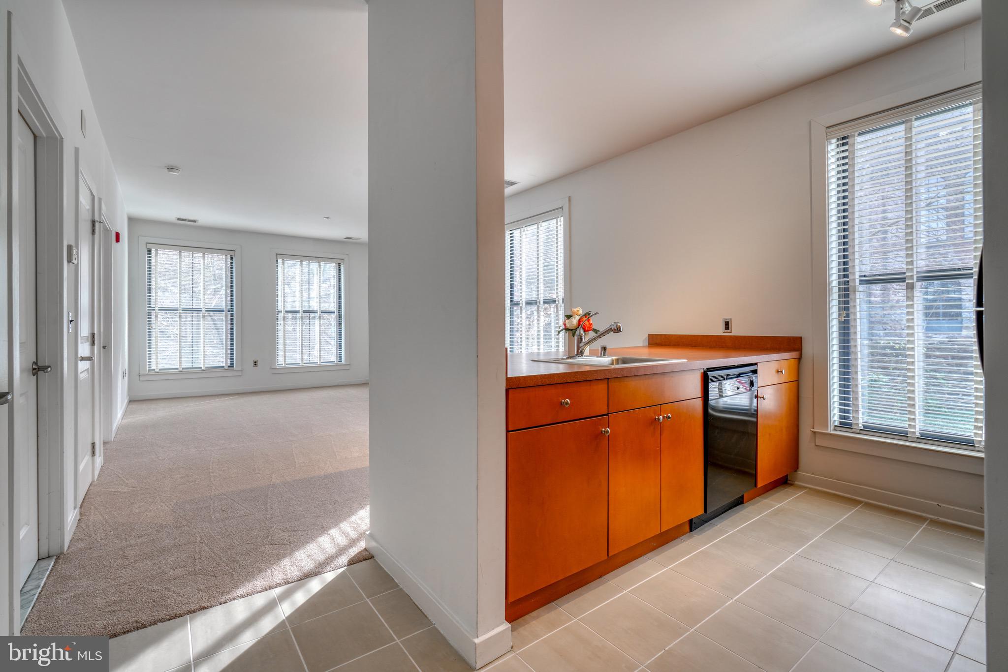 2007 Clipper Park Road, Unit 123 Baltimore, MD 21211 - Photo 3 of 25 a utility room with stainless steel appliances granite countertop a stove and a window