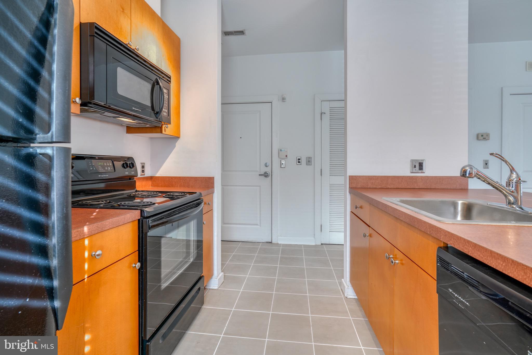 2007 Clipper Park Road, Unit 123 Baltimore, MD 21211 - Photo 6 of 25 a kitchen with stainless steel appliances granite countertop a sink stove and refrigerator