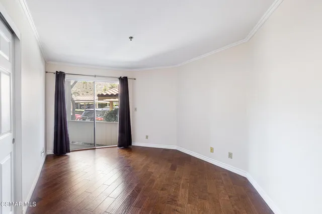 a bedroom with a bed a mirror and a window