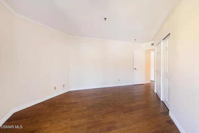 a bathroom with a toilet a sink a mirror and vanity