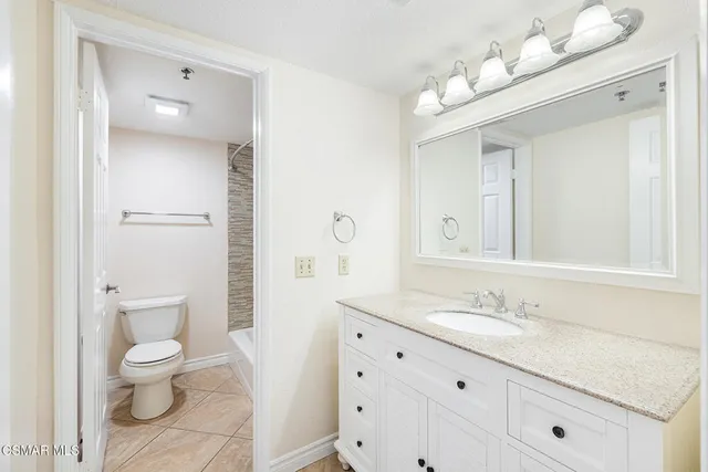 a bathroom with a toilet and shower