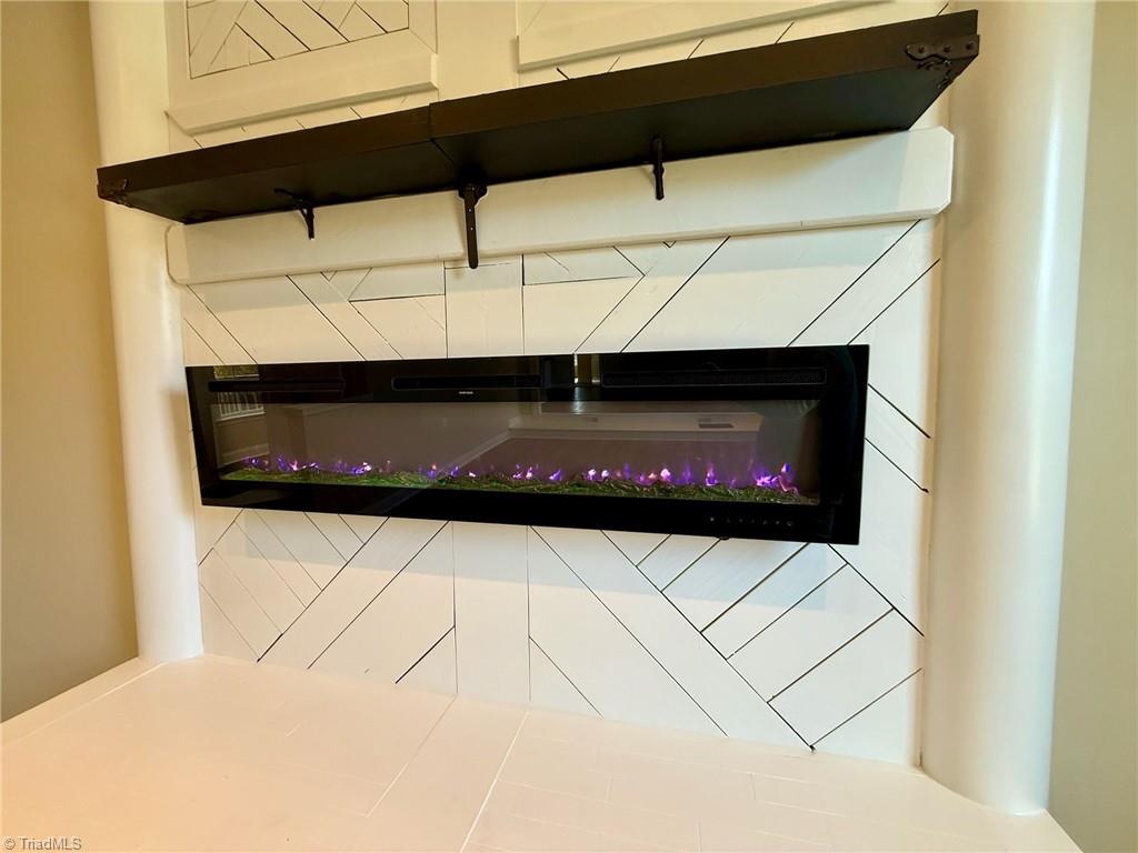 2212 Becks Church Road Lexington, NC 27292 - Photo 12 of 34 Newly installed electric fireplace to keep you cozy through the winter with fun colored fire.