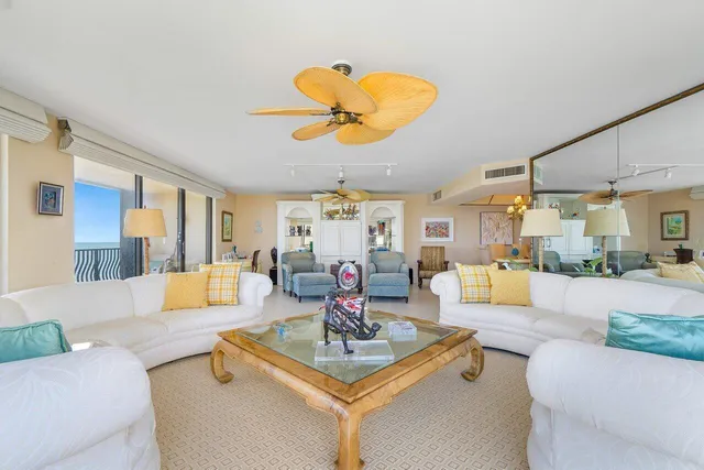 a living room with fireplace furniture and a large window