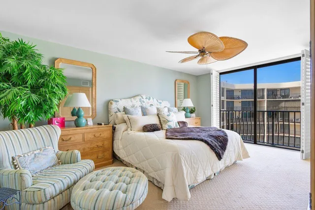 a spacious bedroom with two beds and a potted plant