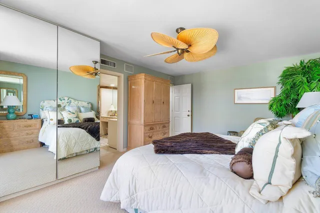 a bedroom with a bed and painting on the wall