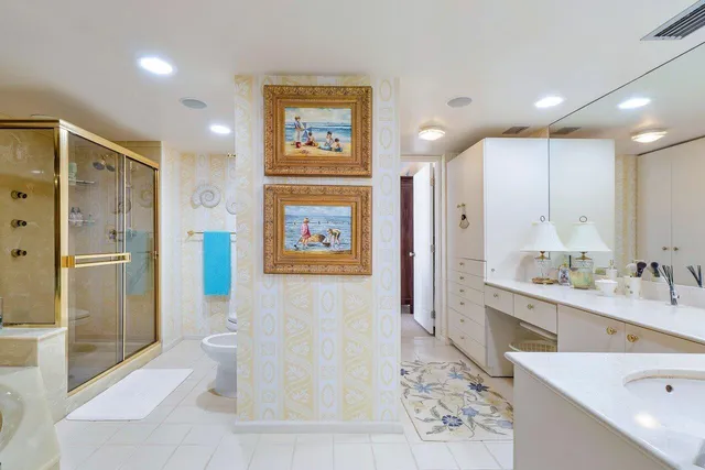a spacious bathroom with a bathtub shower sink mirror and toilet