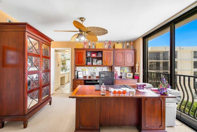 a dining room with furniture and a large window