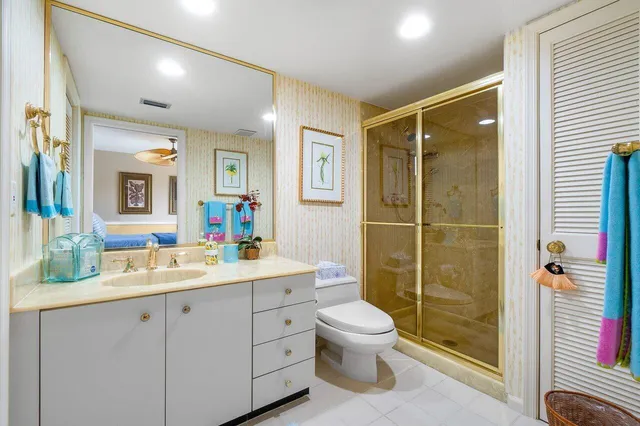 a bathroom with a double vanity sink toilet and shower