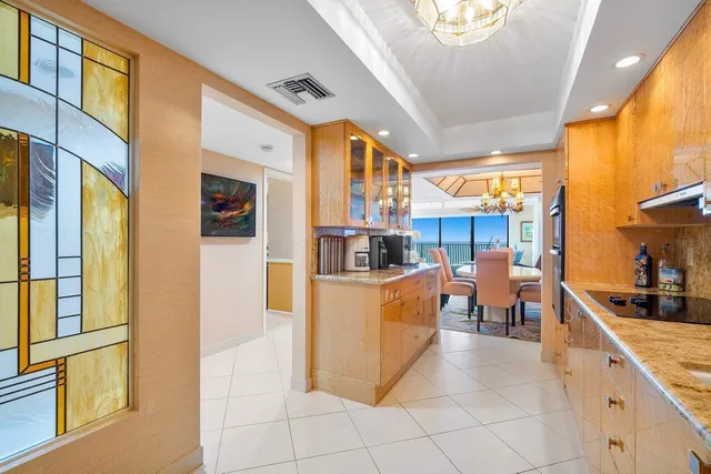 a kitchen with stainless steel appliances granite countertop a refrigerator and a stove