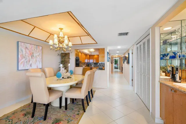 a dining room with furniture and a chandelier