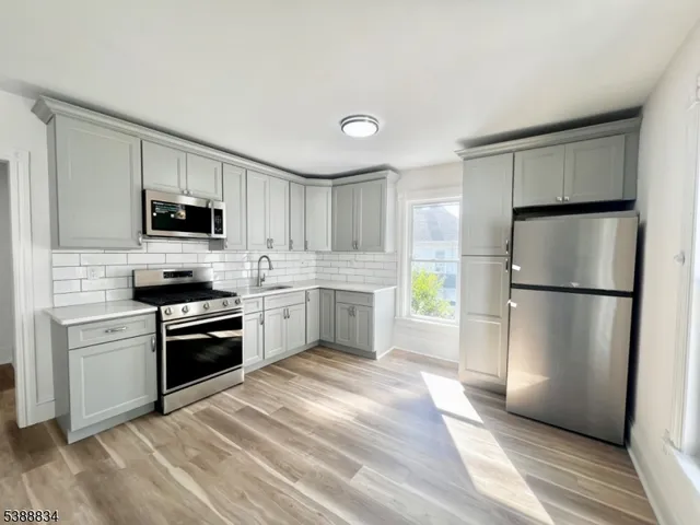 a kitchen with a refrigerator stove and microwave