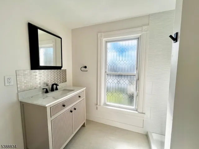 a white toilet sitting next to a bathroom sink