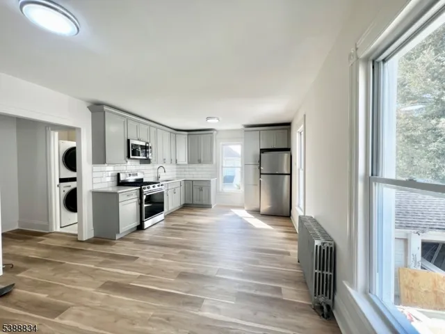 a large white kitchen with cabinets and stainless steel appliances