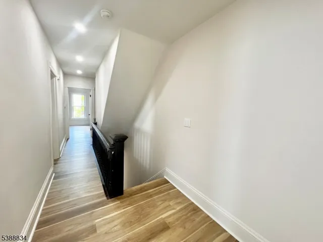 a view of an empty room and wooden floor