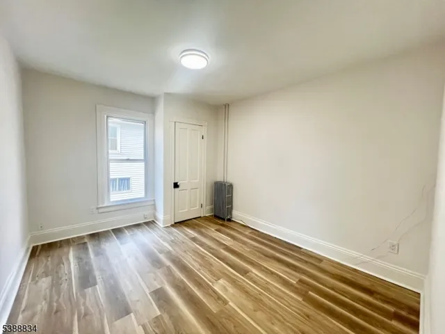 a view of a livingroom with wooden floor and closet area
