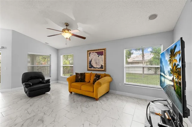 a kitchen with stainless steel appliances kitchen island granite countertop a sink a stove a refrigerator cabinets and chairs