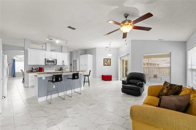a kitchen with granite countertop a sink stove and cabinets