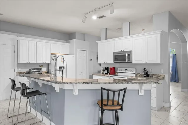 a kitchen with a sink and a refrigerator
