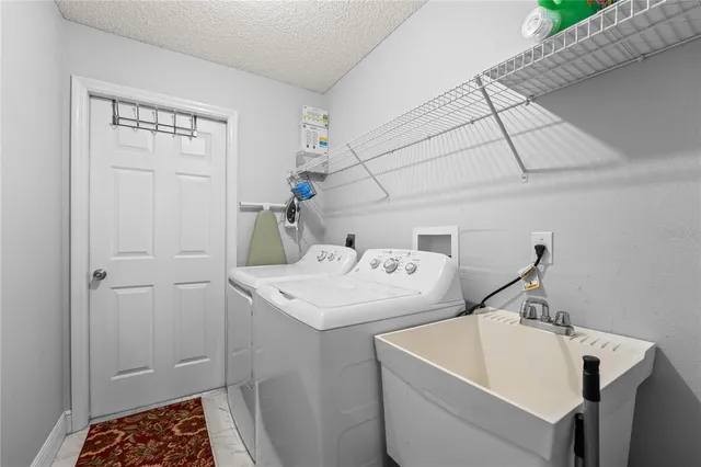 a green field with lots of trees in front of it