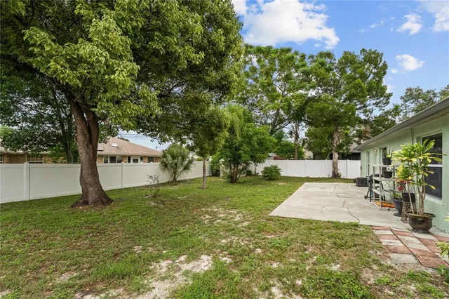 a view of a swimming pool with a table and chairs under an umbrella