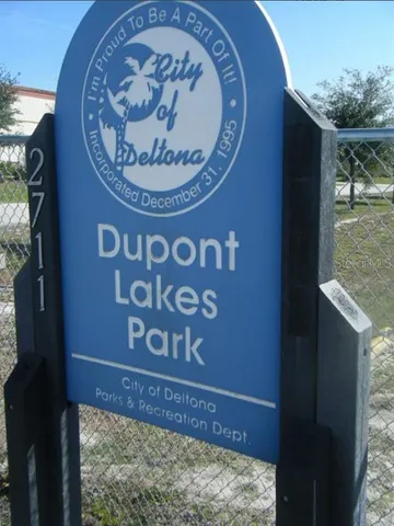 an outdoor space with lots of pool table and chairs