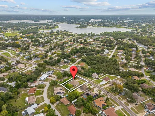 a view of a dining room with furniture a chandelier and wooden floor