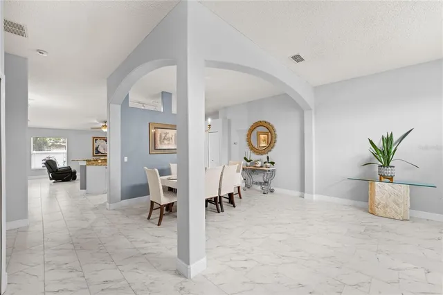 a view of a dining room with furniture and chandelier