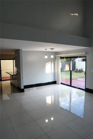 a view of a hallway with two room and a window