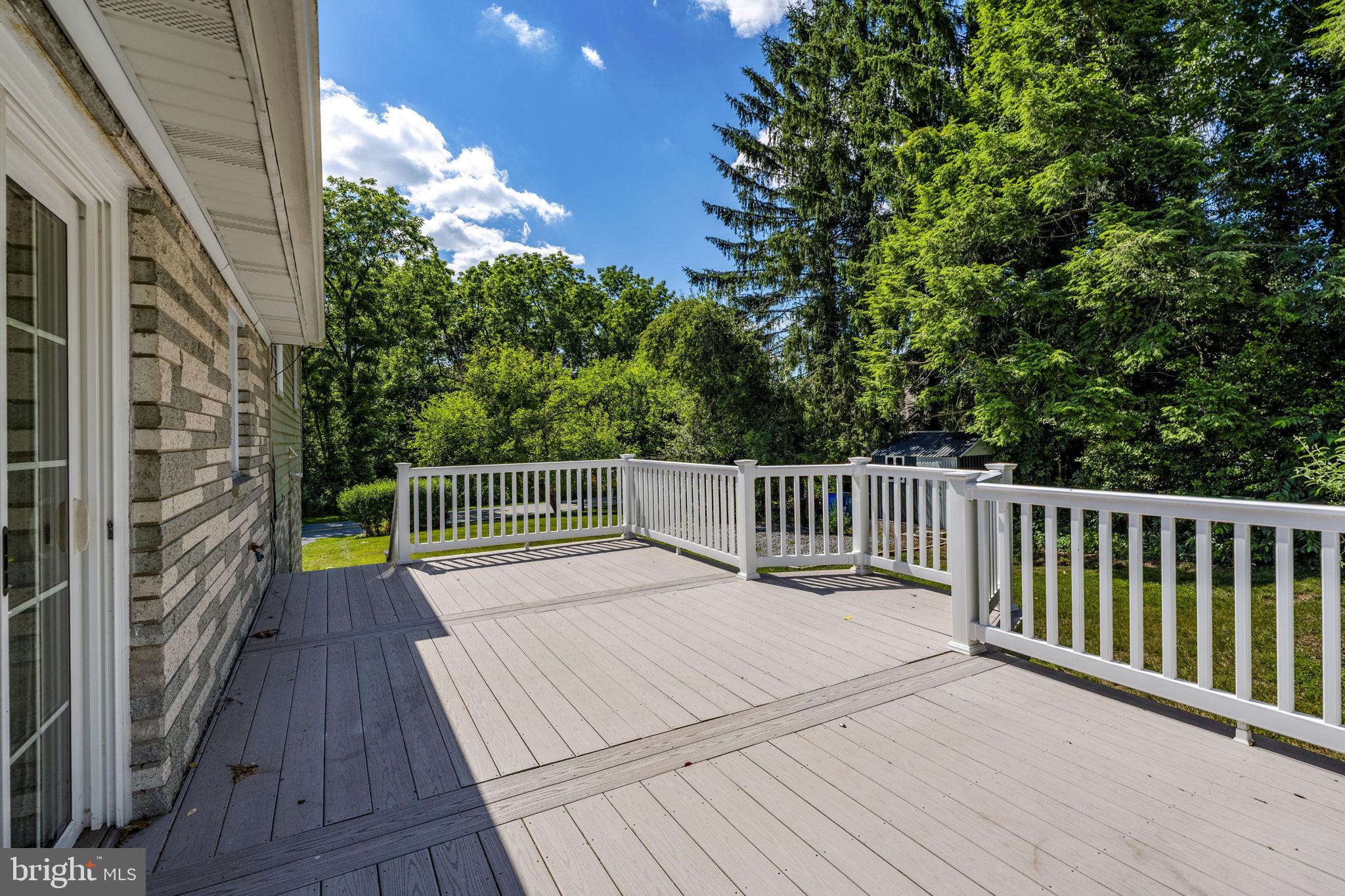 4107 Trowbridge Road York, PA 17402 - Photo 41 of 50 Spacious deck with serene greenery.