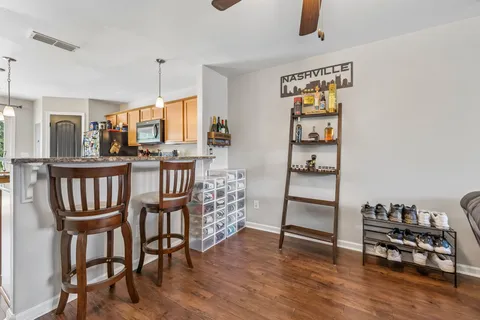 a view of a dining room with furniture and wooden floor