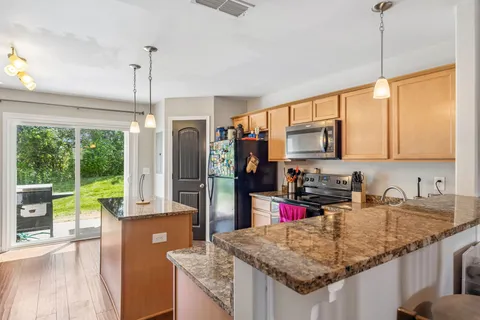a kitchen with sink refrigerator and microwave