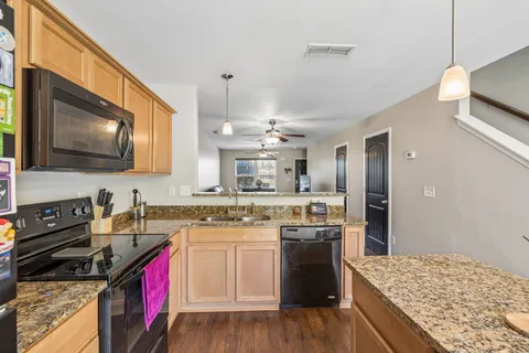 a kitchen with a stove and a sink