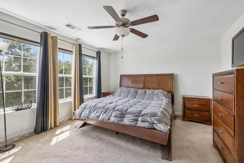 a bedroom with a bed and window