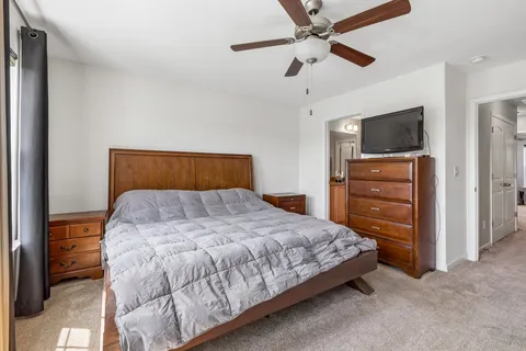 a bedroom with a bed and a television