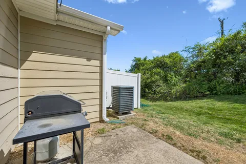a backyard of a house with plants and tree