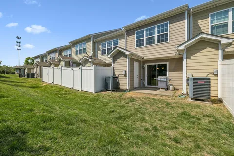 a view of a house with a yard and garage