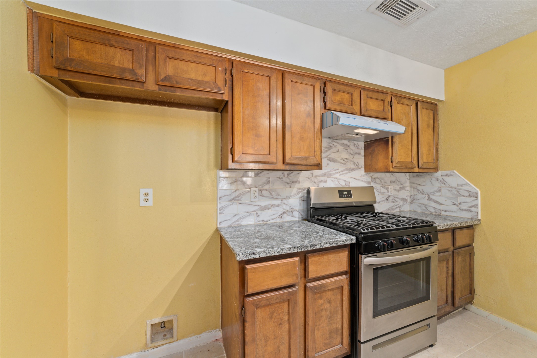 4222 Amir Street Houston, TX 77072 - Photo 15 of 21 a kitchen with granite countertop cabinets stainless steel appliances and a counter space